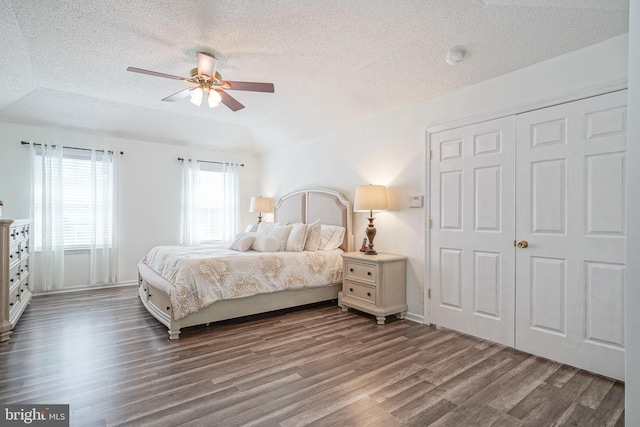 bedroom with a ceiling fan, a closet, a textured ceiling, and wood finished floors