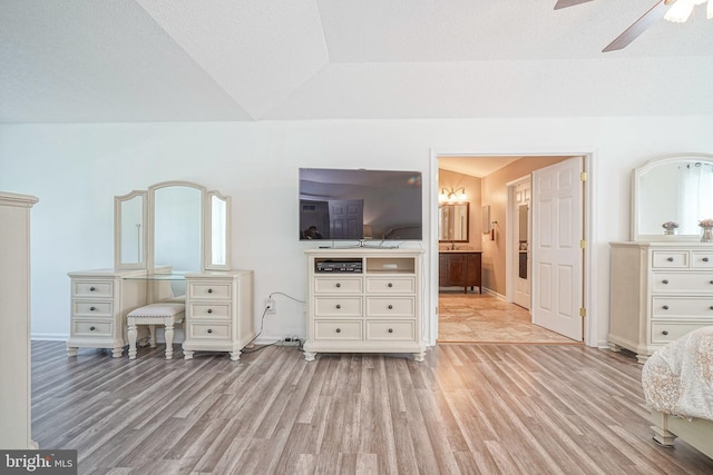 unfurnished bedroom with a ceiling fan, baseboards, a textured ceiling, and light wood finished floors