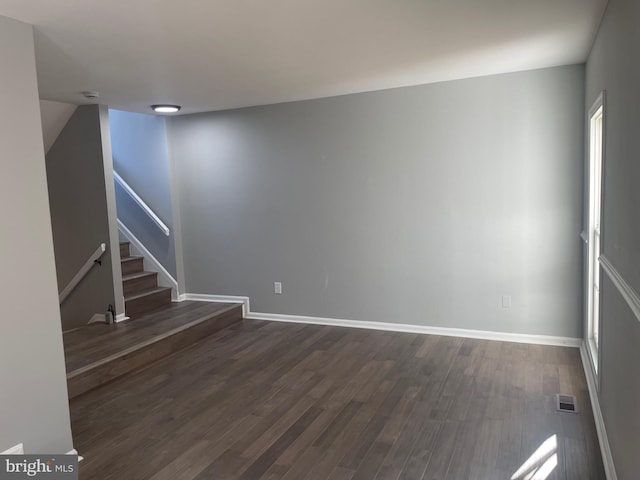 interior space with visible vents, stairs, baseboards, and dark wood-style flooring