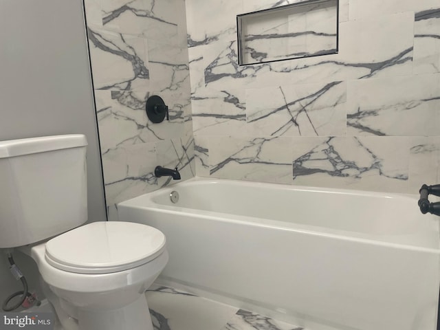 full bathroom featuring toilet, marble finish floor, and shower / washtub combination