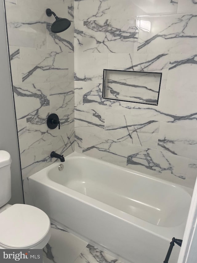 bathroom with toilet, marble finish floor, and shower / bathtub combination