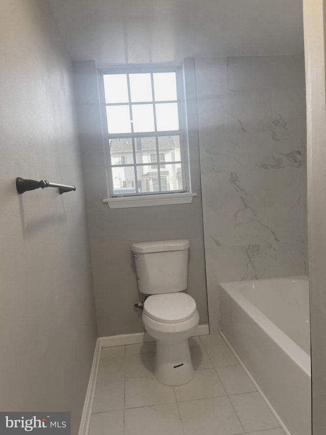 bathroom with walk in shower, toilet, baseboards, and a washtub