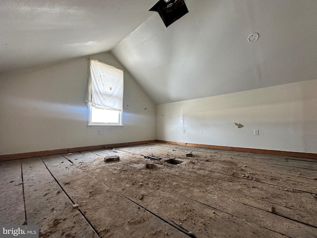 additional living space with vaulted ceiling and baseboards