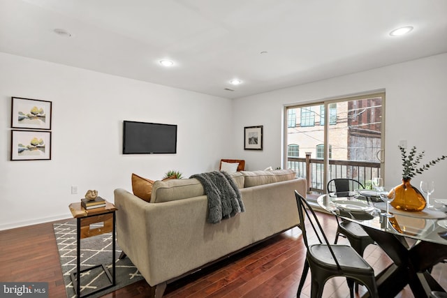 living room featuring baseboards, dark wood-type flooring, and recessed lighting