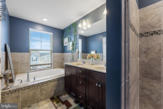 full bathroom with double vanity, a sink, a bath, and tile patterned floors