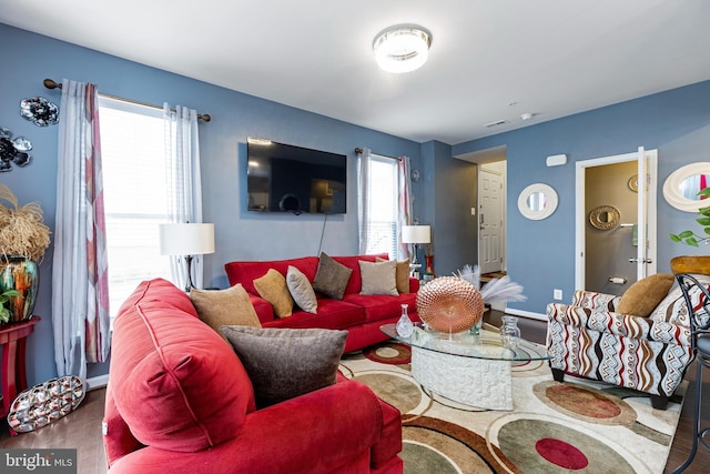 living room featuring a healthy amount of sunlight and baseboards