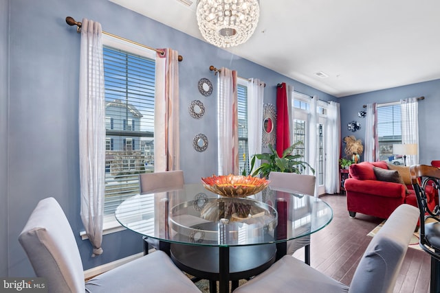 dining space with visible vents and wood finished floors