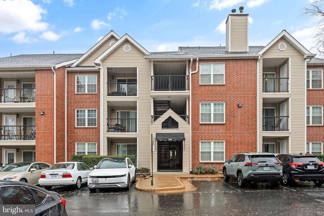 view of building exterior with uncovered parking