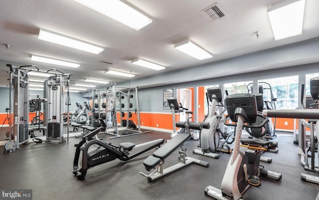 workout area featuring baseboards and visible vents