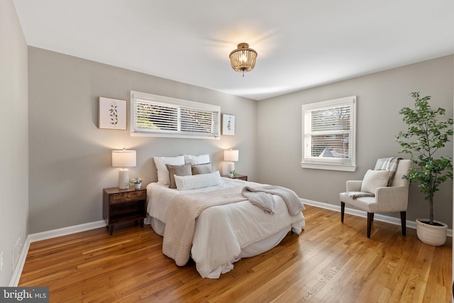 bedroom with light wood-style flooring and baseboards