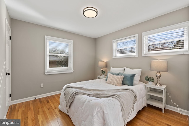 bedroom featuring baseboards and light wood-type flooring