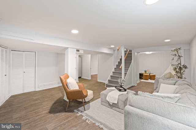 living room featuring visible vents, recessed lighting, stairway, and wood finished floors