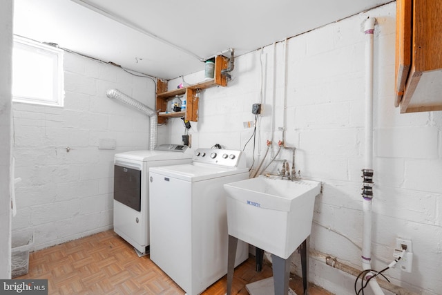 laundry area featuring a sink, laundry area, and washing machine and clothes dryer