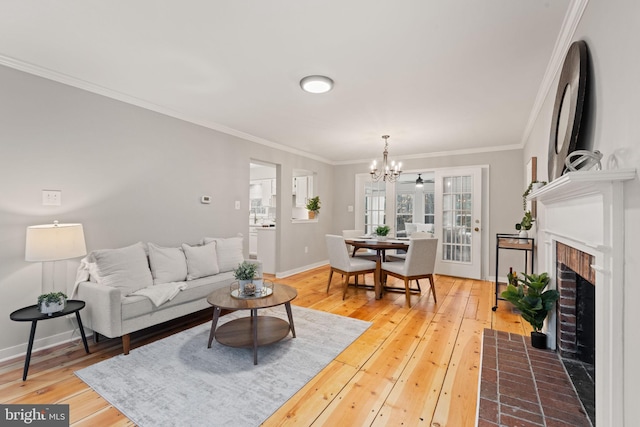 living area featuring ornamental molding, wood-type flooring, and baseboards