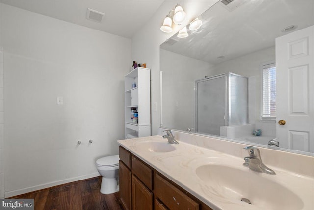 bathroom featuring visible vents, a sink, a shower stall, and toilet