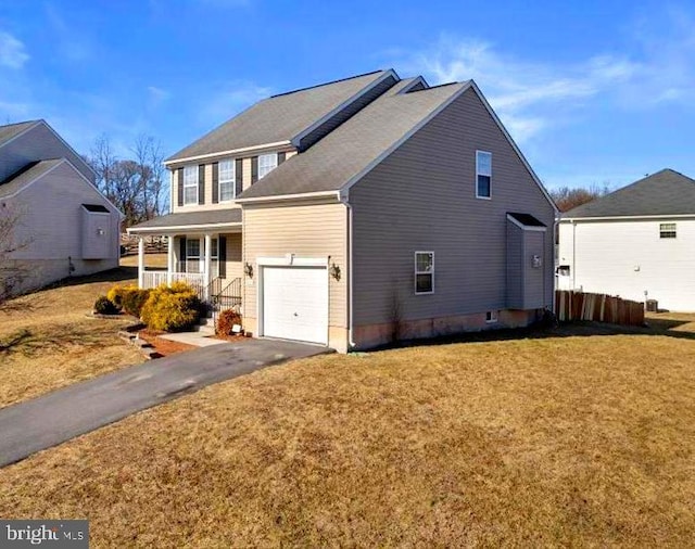 exterior space with covered porch, driveway, and a front yard