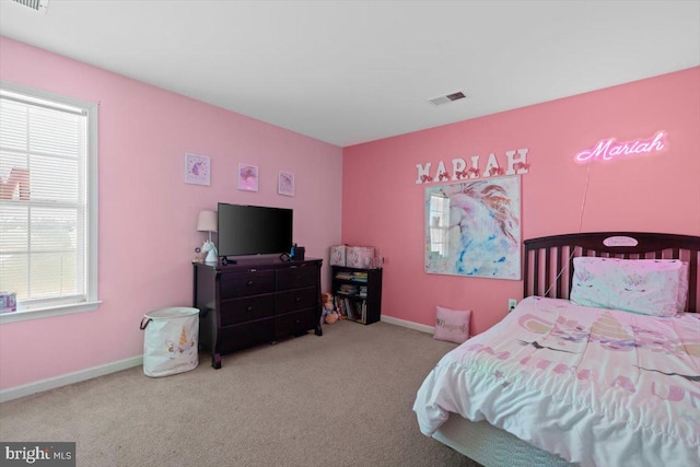 bedroom with carpet floors, baseboards, and visible vents