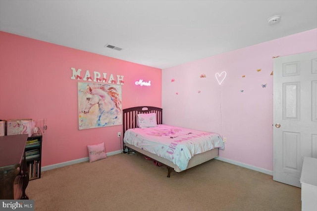 carpeted bedroom featuring baseboards and visible vents