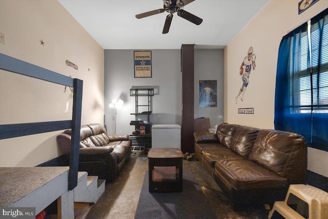 living room featuring a ceiling fan and concrete flooring