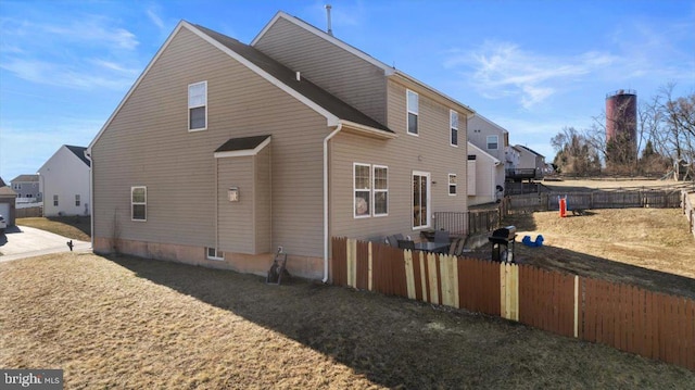 view of side of home featuring fence