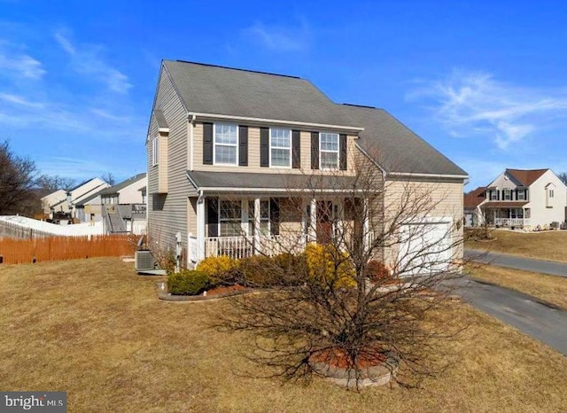 view of front of home featuring aphalt driveway, fence, cooling unit, a porch, and a front yard