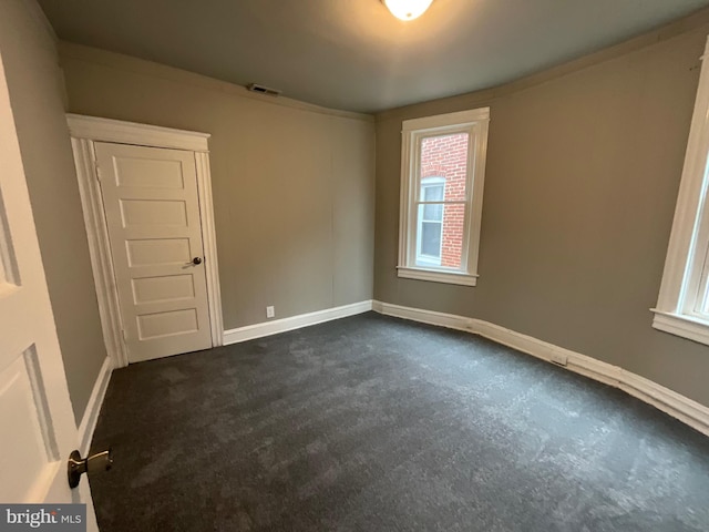 empty room with visible vents and baseboards