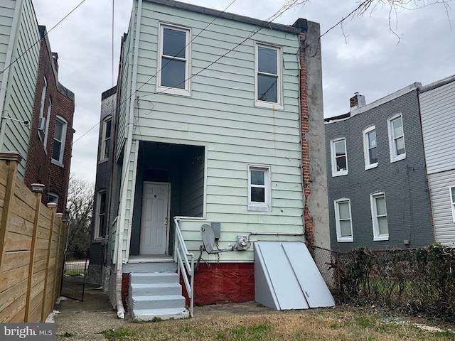 back of house with fence