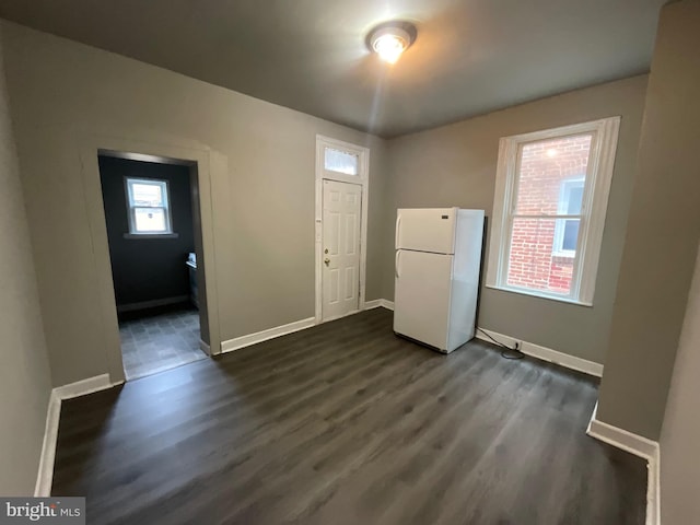 interior space featuring dark wood-style floors and baseboards