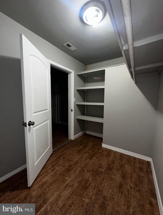 walk in closet with visible vents and wood finished floors