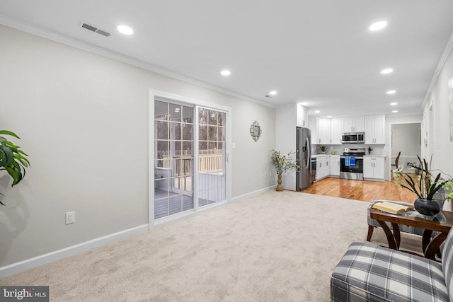 living area featuring light carpet, baseboards, and crown molding