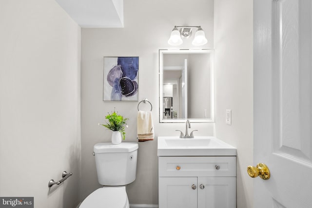 half bath with vanity and toilet