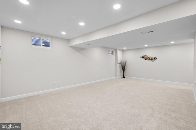 finished basement with recessed lighting, visible vents, and light colored carpet