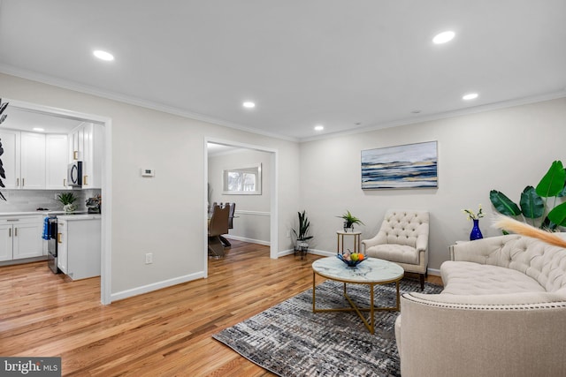 living area featuring crown molding, recessed lighting, and light wood-style floors