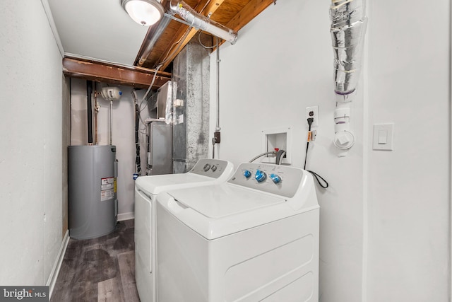 clothes washing area with water heater, washer and clothes dryer, wood finished floors, and baseboards