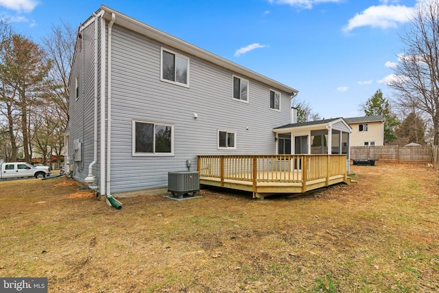 back of property with a yard, central AC, fence, and a deck