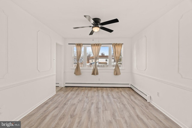 unfurnished room featuring light wood-style floors, ceiling fan, and baseboards