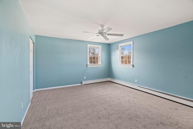 empty room with carpet floors, a baseboard radiator, baseboards, and a ceiling fan