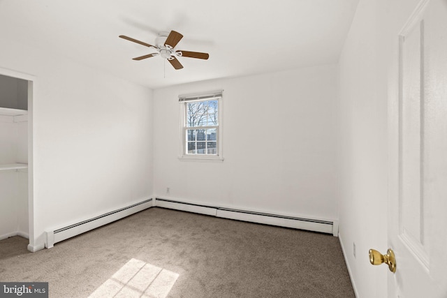 unfurnished bedroom with a baseboard heating unit, carpet flooring, and a ceiling fan