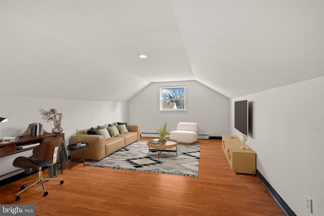 living room featuring a baseboard radiator, vaulted ceiling, and wood finished floors