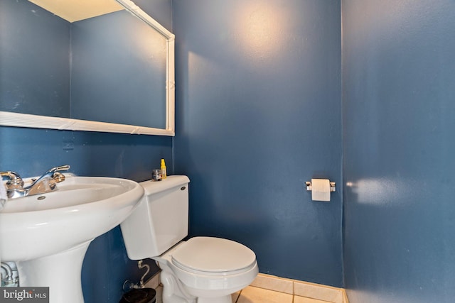 bathroom featuring toilet and tile patterned flooring