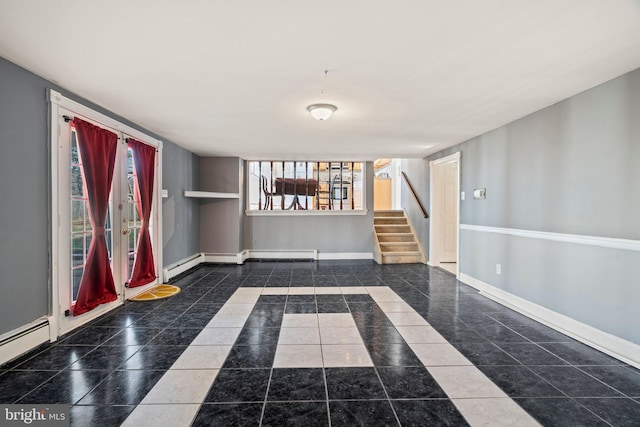 interior space with baseboard heating, stairway, and baseboards