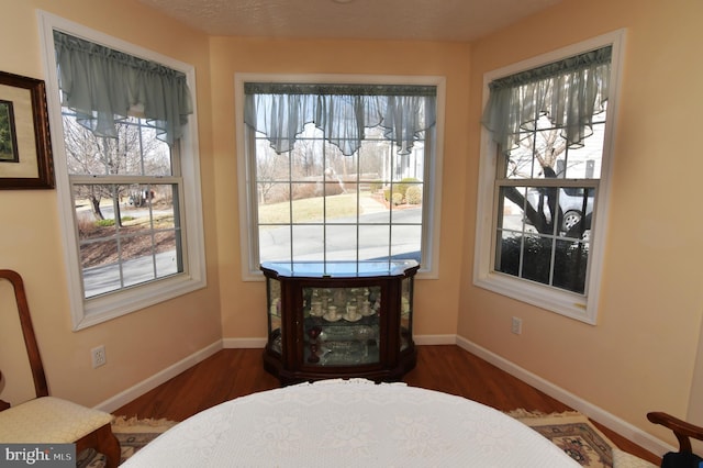 interior space featuring dark wood-type flooring and baseboards