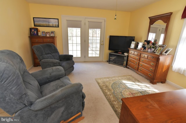 carpeted living area with baseboards