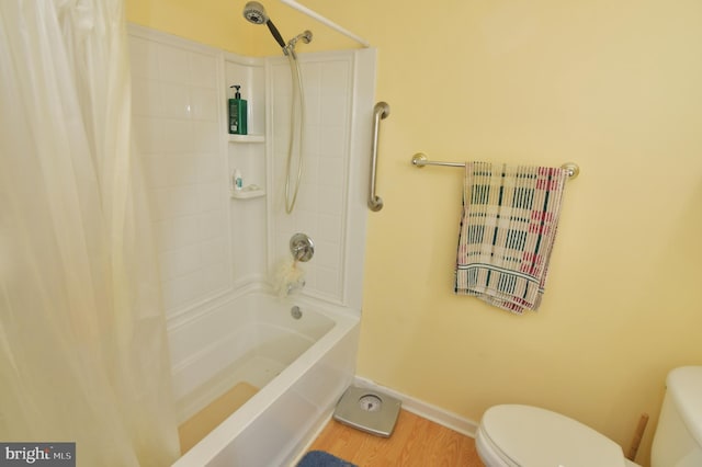 bathroom featuring shower / bath combo, baseboards, toilet, and wood finished floors