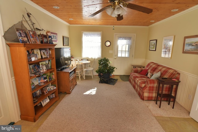 living room featuring a wainscoted wall, wood ceiling, ornamental molding, and light colored carpet