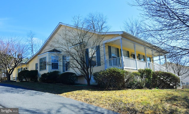 view of side of home featuring a lawn