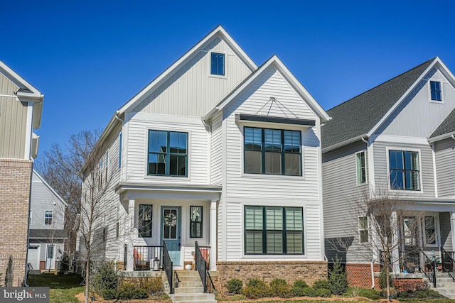 modern farmhouse featuring board and batten siding and brick siding