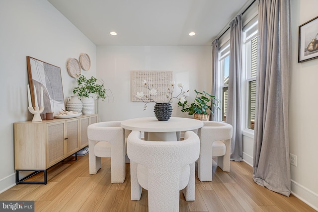 dining room featuring baseboards, recessed lighting, and light wood-style floors