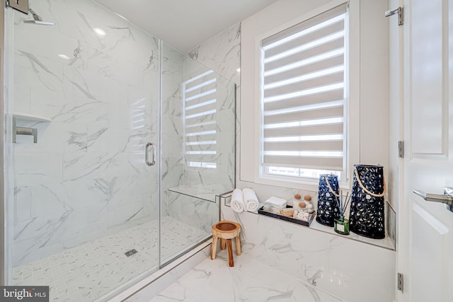 bathroom with marble finish floor and a marble finish shower