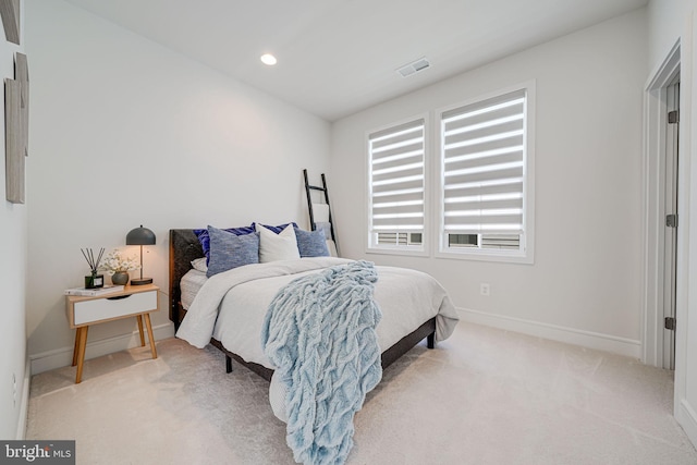 bedroom with light carpet, recessed lighting, visible vents, and baseboards